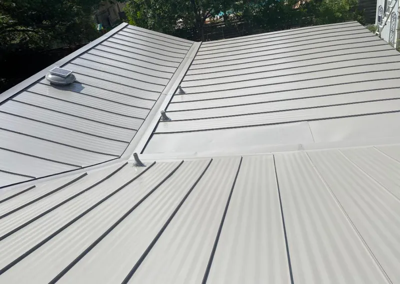 Solar attic fan installed on a metal roof for Roof Ventilation in Pecan Plantation